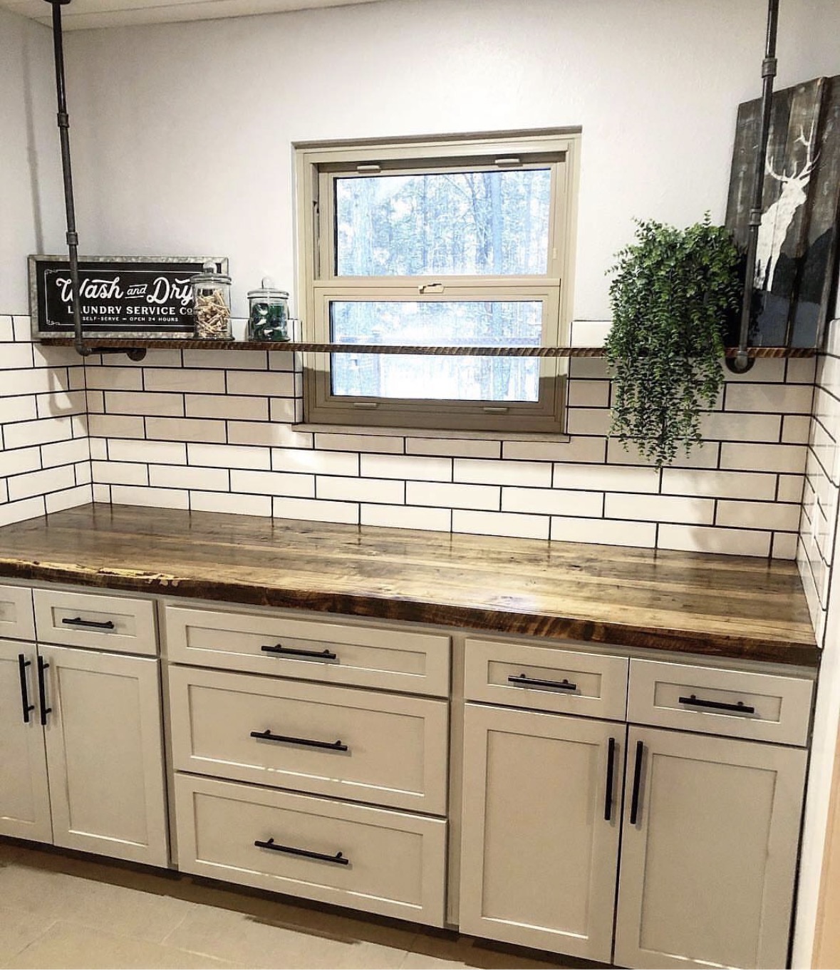 Laundry & prep room — Live-edge counter, subway backsplash, black-pipe shelving